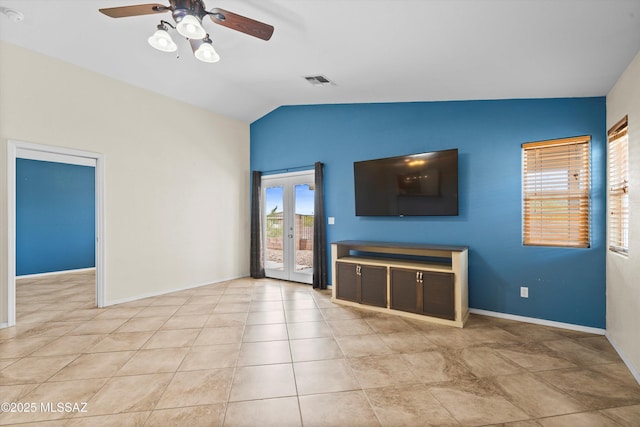 unfurnished living room with vaulted ceiling, light tile patterned flooring, ceiling fan, and french doors