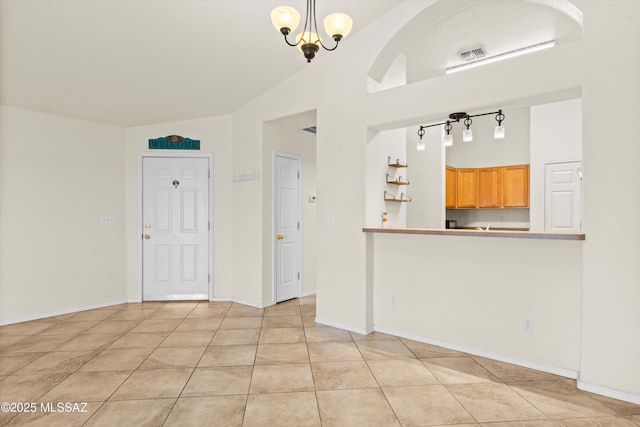 interior space with pendant lighting, light tile patterned floors, and a chandelier