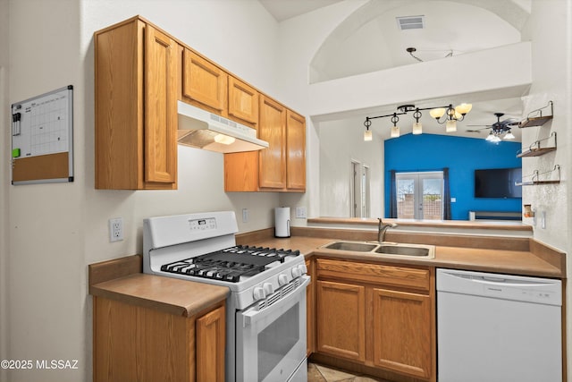 kitchen with french doors, sink, ceiling fan, kitchen peninsula, and white appliances