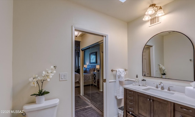 bathroom with vanity and toilet