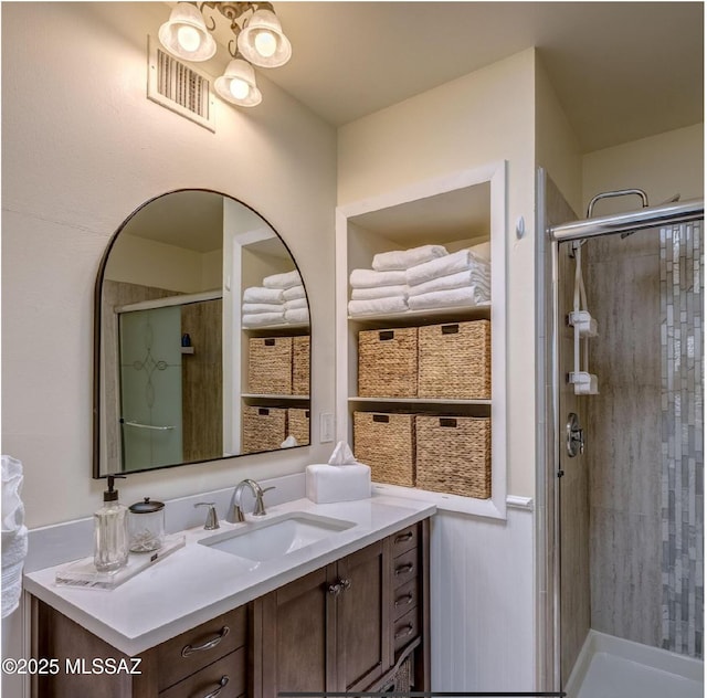 bathroom featuring vanity and a shower with door