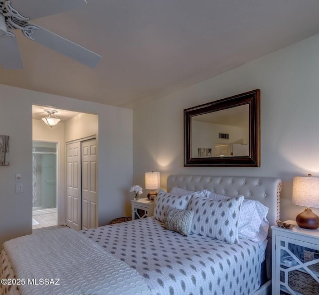 bedroom featuring ensuite bath, ceiling fan, and a closet