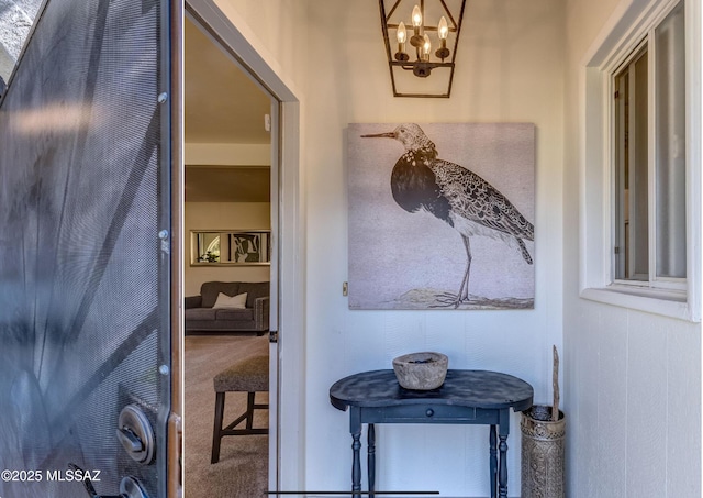 interior space featuring a notable chandelier and carpet