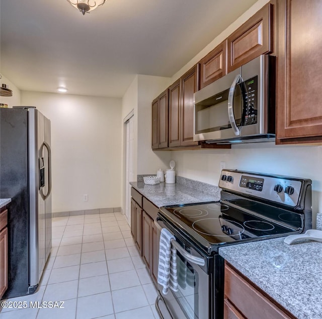 kitchen with stainless steel appliances and light tile patterned floors