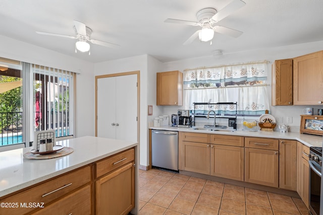 kitchen featuring dishwasher, sink, light tile patterned floors, and ceiling fan