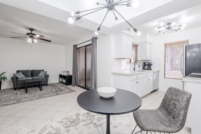 interior space with ceiling fan with notable chandelier and sink