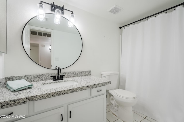 bathroom with tile patterned floors, vanity, and toilet