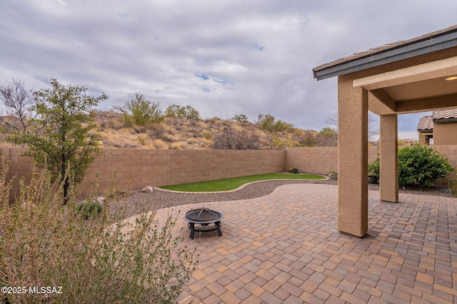 view of patio / terrace with an outdoor fire pit