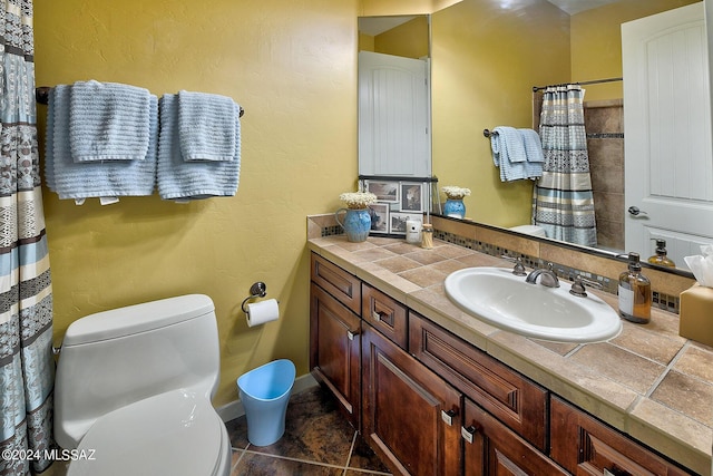 bathroom featuring tile patterned floors, vanity, and toilet