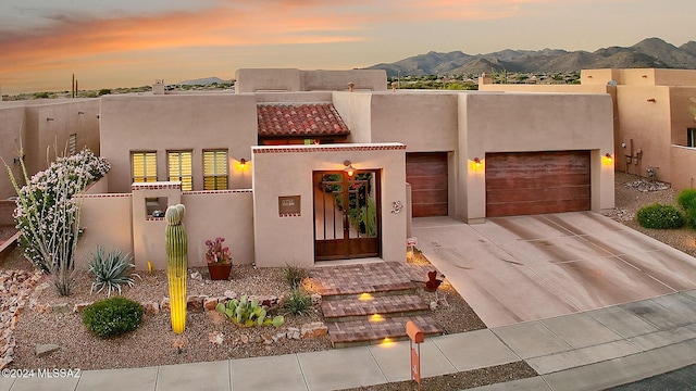 pueblo revival-style home featuring a mountain view