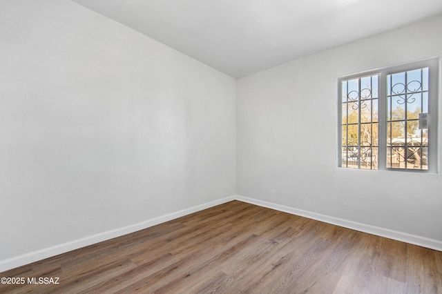 empty room with wood-type flooring