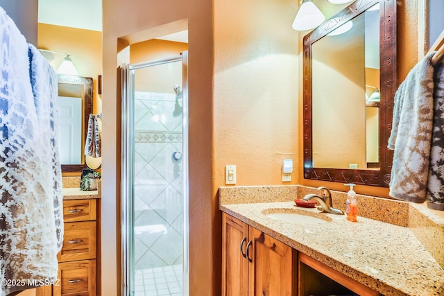 bathroom featuring vanity and an enclosed shower