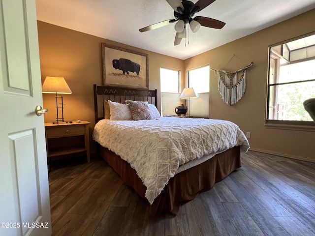 bedroom featuring ceiling fan, dark wood-type flooring, and a textured ceiling