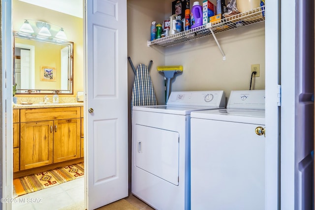 clothes washing area featuring sink, washing machine and dryer, and light tile patterned floors