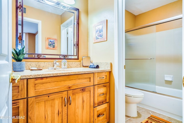 full bathroom with toilet, vanity, shower / bath combination with glass door, and tile patterned flooring