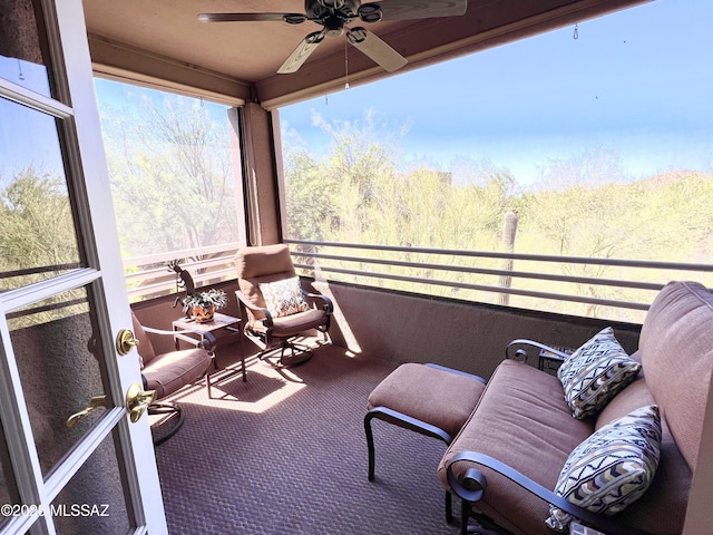 sunroom featuring ceiling fan