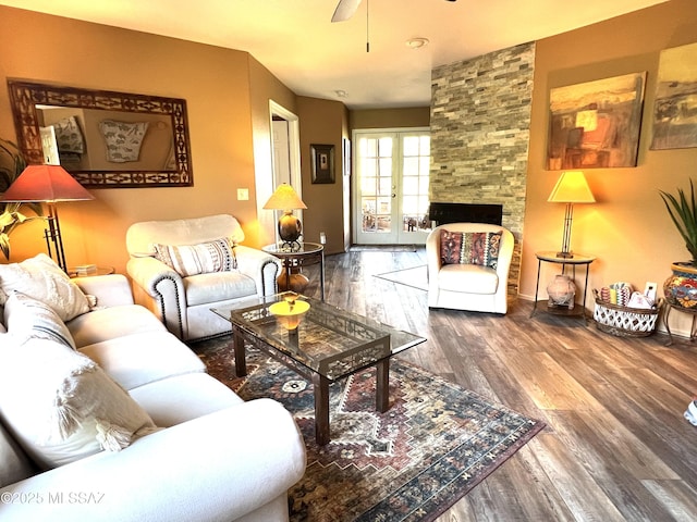 living room featuring wood-type flooring, ceiling fan, and french doors