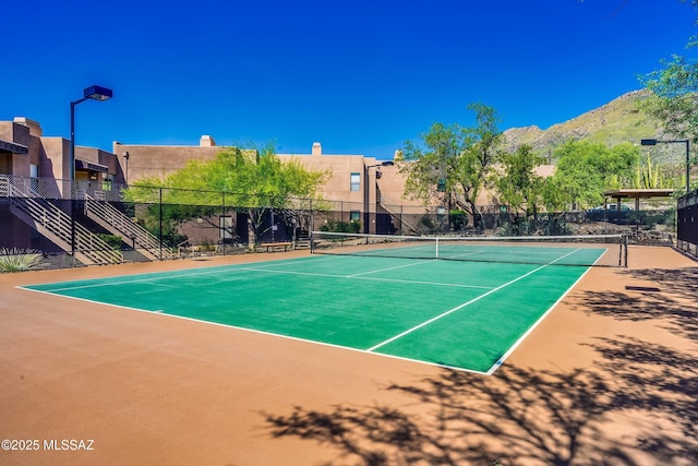 view of tennis court with a mountain view