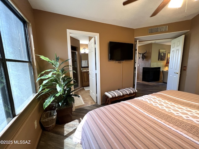 bedroom featuring dark hardwood / wood-style floors and ensuite bathroom