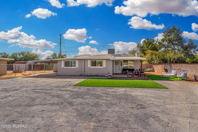 rear view of property featuring a lawn