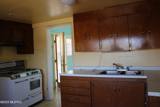 kitchen with range with two ovens and sink