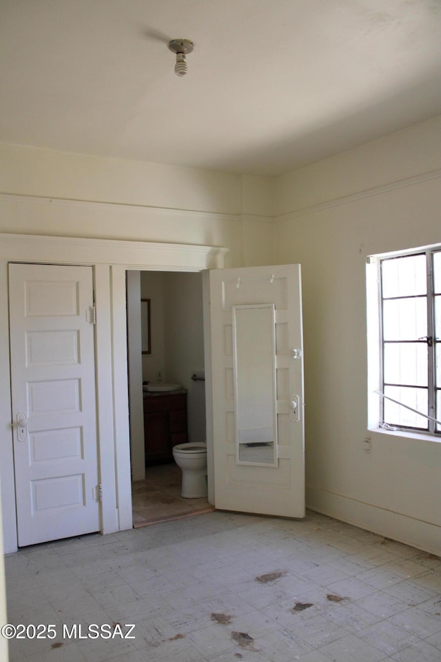 unfurnished bedroom with ensuite bathroom