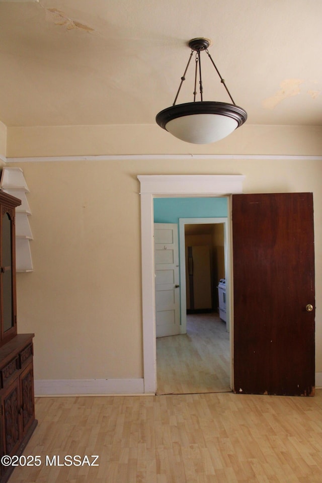 unfurnished dining area with light wood-type flooring