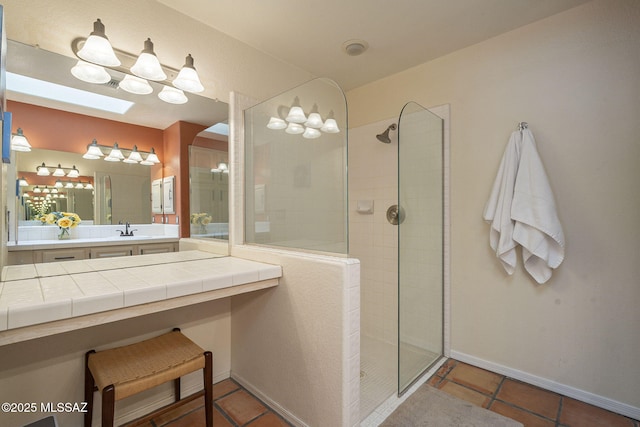 bathroom with tile patterned flooring, sink, and a tile shower