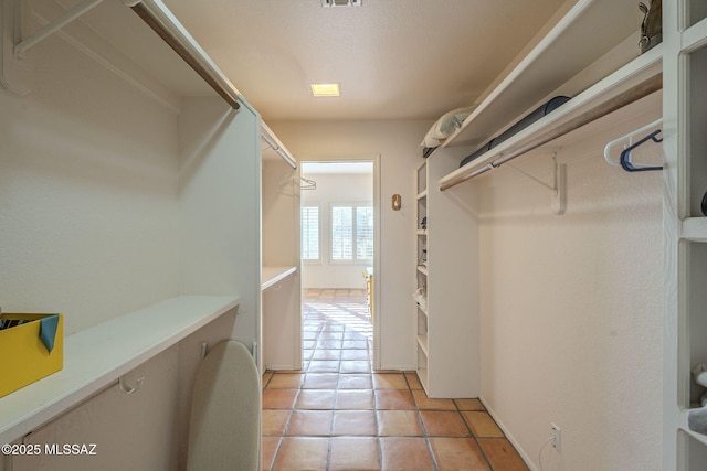 walk in closet featuring light tile patterned flooring