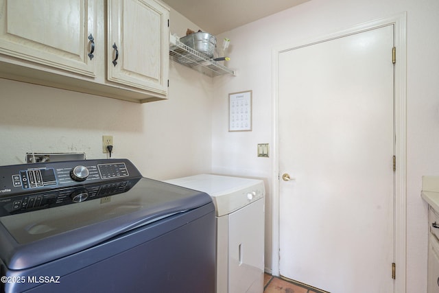 washroom with cabinets and washer and dryer