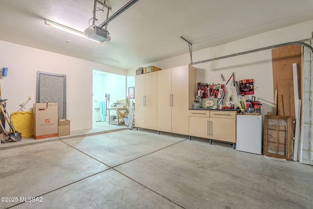 garage with fridge and a garage door opener