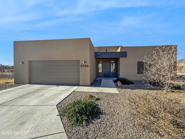 pueblo-style home with a garage