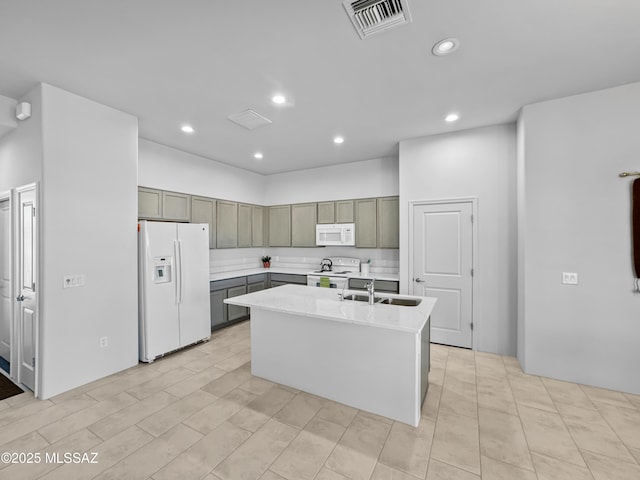 kitchen with a sink, white appliances, light countertops, visible vents, and recessed lighting