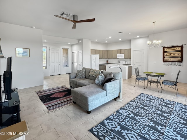 living area featuring ceiling fan with notable chandelier, visible vents, recessed lighting, and light tile patterned flooring