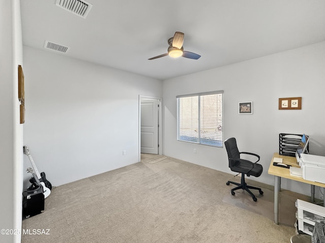 carpeted office space with visible vents and ceiling fan