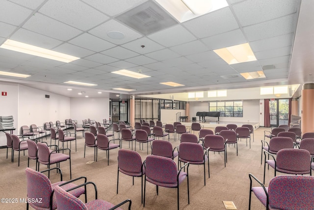 misc room with a paneled ceiling, visible vents, and light carpet
