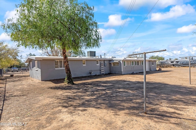 back of property featuring central AC