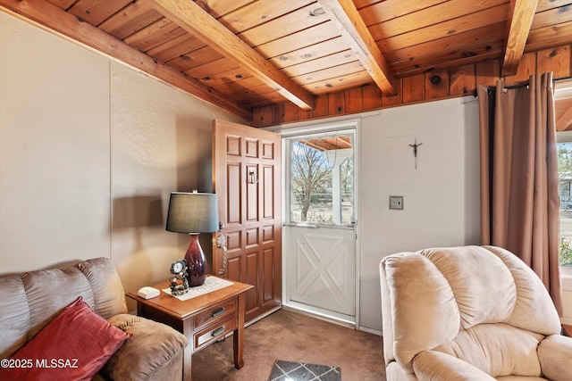 foyer with wooden ceiling, beamed ceiling, and carpet