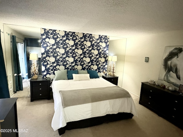 bedroom featuring carpet and a textured ceiling