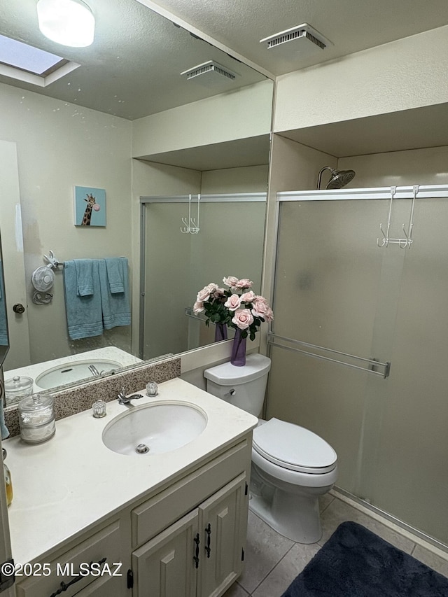 bathroom with tile patterned flooring, visible vents, a stall shower, and a skylight