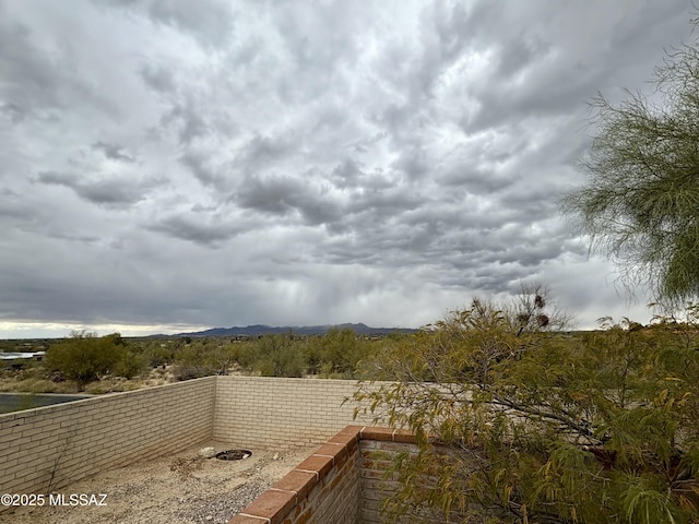 view of water feature with a mountain view and fence