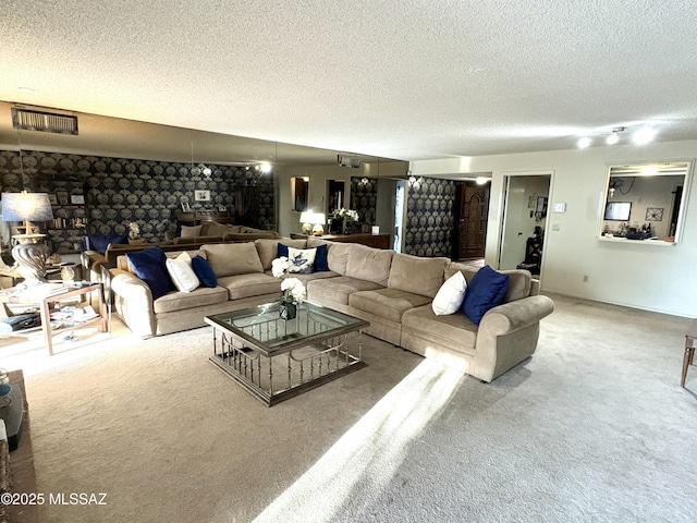 living area featuring visible vents, carpet floors, and a textured ceiling