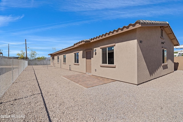 back of property featuring a patio area