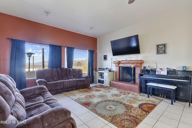 tiled living room featuring lofted ceiling and a brick fireplace