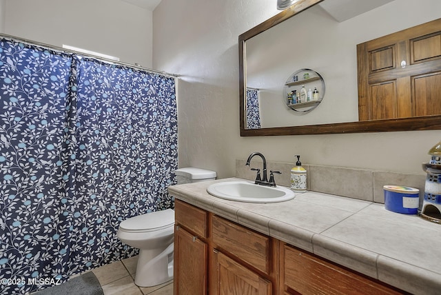 bathroom featuring vanity, tile patterned flooring, and toilet