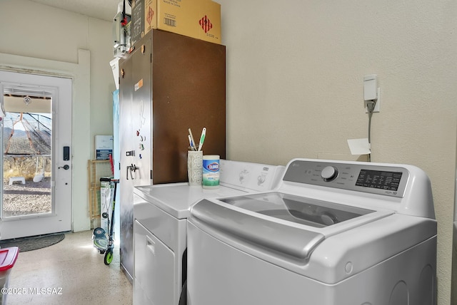 laundry room featuring a wealth of natural light and washer and clothes dryer