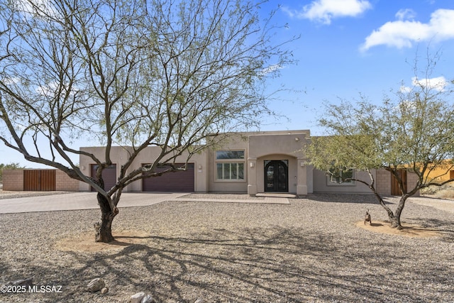 pueblo-style house with a garage