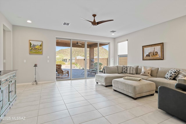 tiled living room with ceiling fan