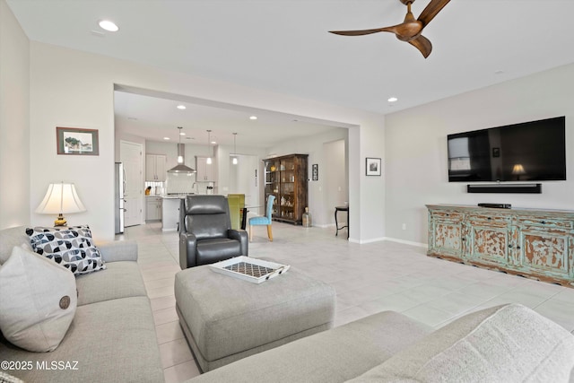 tiled living room with sink and ceiling fan