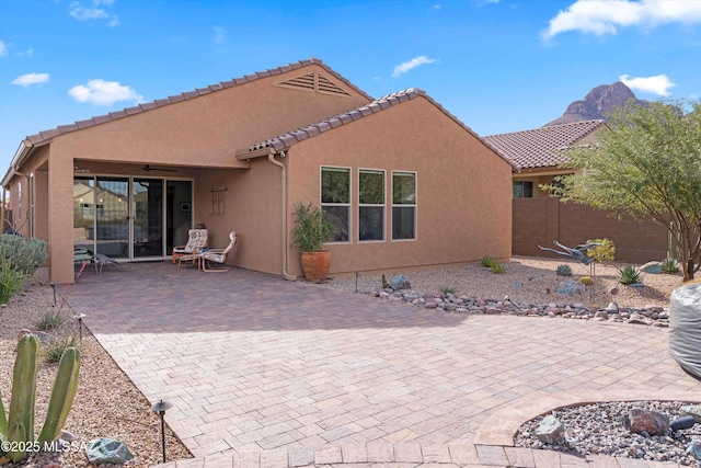 back of property featuring a patio and ceiling fan